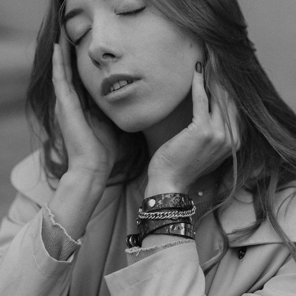 Silhouette of a person meditating in front of a fractal light pattern.